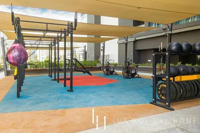 a gym with a row of exercise equipment in a building at LUX The 15 Northside Burj Khalifa View Suite in Dubai
