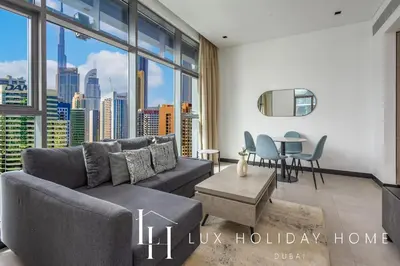 a living room with a couch and a table at LUX The 15 Northside Burj Khalifa View Suite in Dubai