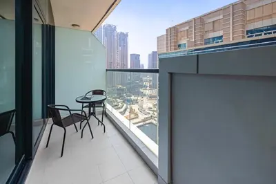 a balcony with a table and chairs on a building at Bays edge in Dubai