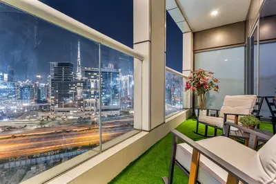 a balcony with a view of a city at Savis Homes - Stylish 1BR in Business Bay with Burj Khalifa View in Damac Paramount Tower in Dubai