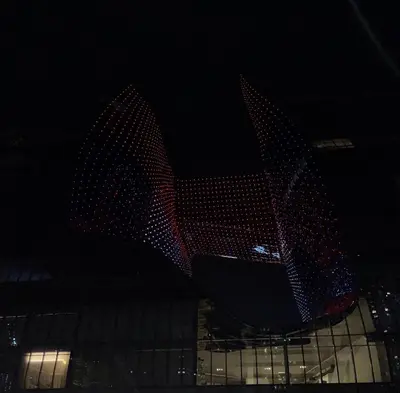a building with lights on it in the dark at The Opus residences 1 bedroom city view in Dubai