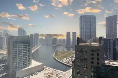 a view of a river in a city with tall buildings at The Opus residences 1 bedroom city view in Dubai