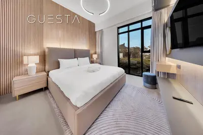 a bedroom with a large bed and a tv at Vida Residences The Hills, Dubai in Dubai