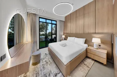 a bedroom with a large bed and a mirror at Vida Residences The Hills, Dubai in Dubai