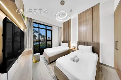 a hotel room with two beds and a tv at Vida Residences The Hills, Dubai in Dubai