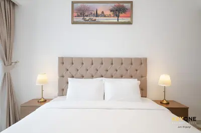 a bedroom with a white bed with two lamps at Splendour Living 1BR at Azizi Riviera in Dubai