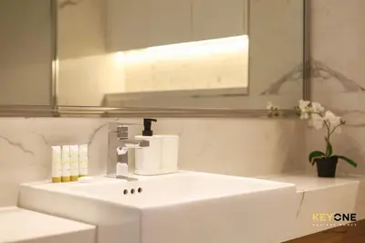 a bathroom with a white sink and a mirror at Splendour Living 1BR at Azizi Riviera in Dubai