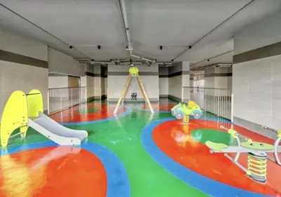 a large room with a play room with a playground at FIRST CLASS 1BR Stylish , Modern Comfort in Dubai