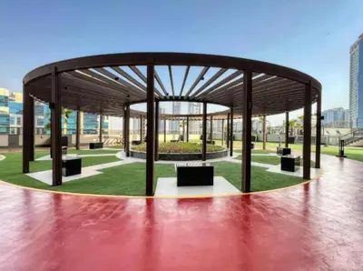 a pavilion with a bench in a park at FIRST CLASS 1BR Stylish , Modern Comfort in Dubai