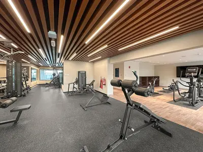 a gym with treadmills and exercise equipment in a room at FIRST CLASS 1BR Stylish , Modern Comfort in Dubai