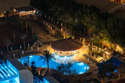 an overhead view of a swimming pool at night at Luxe 3BR and Maid Room with Panoramic Dubai Eye View - JBR Beach in Dubai