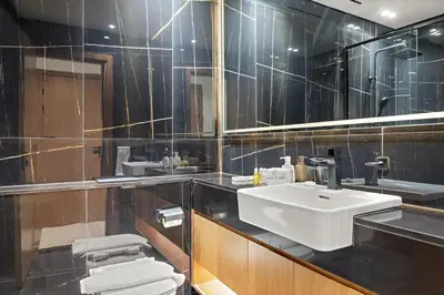 a bathroom with a sink and a toilet at FIRST CLASS 1BR Minimalist Elegance in Dubai