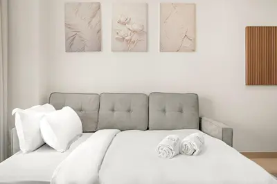 a bedroom with a bed with two slippers on it at FIRST CLASS 1BR Minimalist Elegance in Dubai
