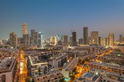 a city skyline at night with tall buildings at FIRST CLASS 1BR Minimalist Elegance in Dubai