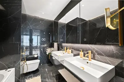 a bathroom with two sinks and two mirrors at Prestigious 2BD Seaside Apartment, The Address JBR in Dubai