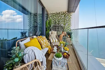 a balcony with a couch and chairs on a building at Prestigious 2BD Seaside Apartment, The Address JBR in Dubai