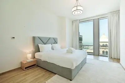 a bedroom with a large bed and a large window at Premium 3-BR Serene Canal View High Floor in Dubai