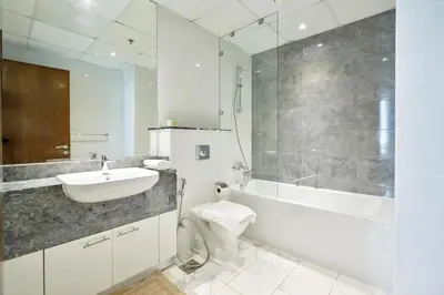 a bathroom with a sink and a toilet and a shower at Premium 3-BR Serene Canal View High Floor in Dubai