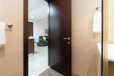 a door leading into a room with a bathroom at Peaceful - Charming - Urban Hideaway in Dubai