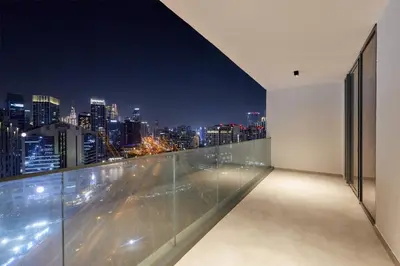 a room with a view of the city at night at Chic 1-Bedroom Retreat in Heart of Business Bay in Dubai