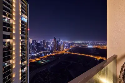 a view of a city at night from a building at Luxury 2BR with Skyline Views Prime Business Bay Location in Dubai