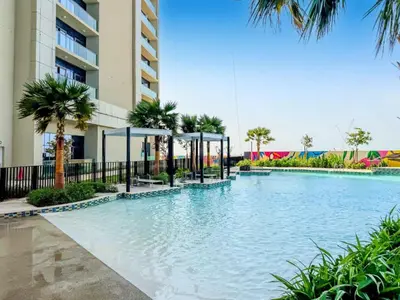 a swimming pool in front of a building at Luxury 2BR with Skyline Views Prime Business Bay Location in Dubai
