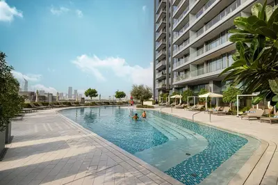 two people in a swimming pool in a building at Vida Dubai Mall! Excellent Amenities, Mall Connected! in Dubai