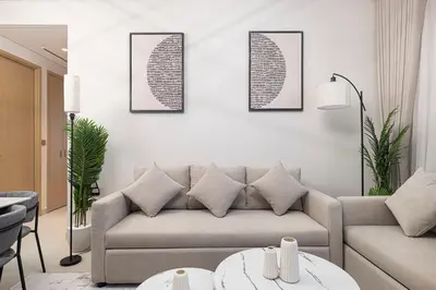 a living room with a couch and a table at Vida Dubai Mall! Excellent Amenities, Mall Connected! in Dubai