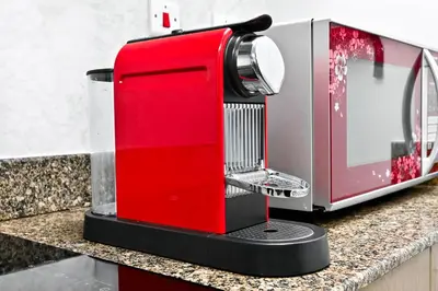 a red appliance sitting on top of a kitchen counter at Torch Dubai Marina 2BDR with Pool Gym and Views in Dubai