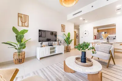 a living room with a couch and a table at Iconic Burj Khalifa View 2BR with Assistant Room, Steps from Dubai Mall and Beside a Park, Bellevue Towers 1, Downtown Dubai by Deluxe Holiday Homes in Dubai