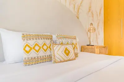 a white bed with four pillows on it at Iconic Burj Khalifa View 2BR with Assistant Room, Steps from Dubai Mall and Beside a Park, Bellevue Towers 1, Downtown Dubai by Deluxe Holiday Homes in Dubai