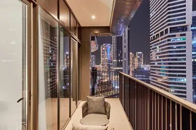 a balcony with a chair and a city skyline at Luxury 1BR in Central Business Bay in Dubai