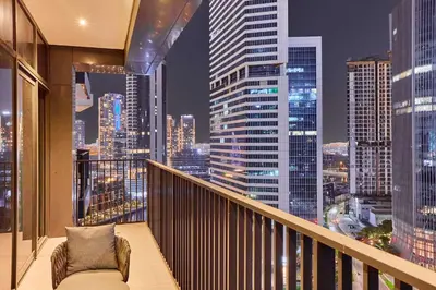 a balcony with a view of a city at night at Luxury 1BR in Central Business Bay in Dubai