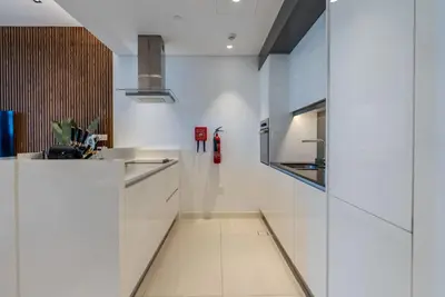 a kitchen with white cabinets and a counter top at TRPS - Bluewaters Residence 3, Bluewaters Island - Ain Dubai View, Fully Furnished, Close to JBR and Marina in Dubai