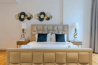 a bedroom with a large bed with blue pillows at TRPS - Bluewaters Residence 3, Bluewaters Island - Ain Dubai View, Fully Furnished, Close to JBR and Marina in Dubai