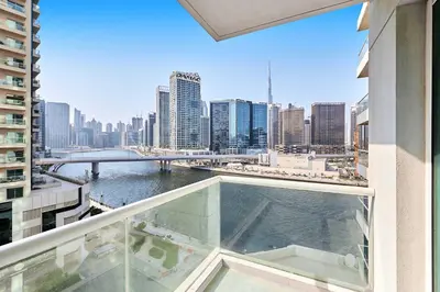 a view of a city skyline from a balcony of a building at Luxury 1BHK with Stunning Canal View Business Bay in Dubai
