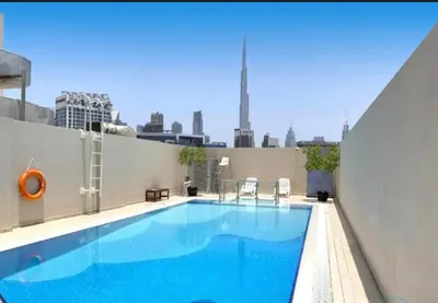 a swimming pool on the roof of a building at Luxury 1BHK with Stunning Canal View Business Bay in Dubai