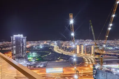 a view of a city at night with lights at Elegant 2BR Apartment Heart of Business Bay High Floor in Dubai