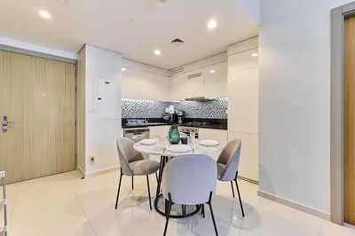 a dining room with a table and chairs in a kitchen at Elegant 2BR Apartment Heart of Business Bay High Floor in Dubai