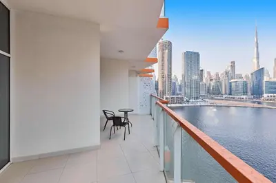 a balcony with a table and chairs and a view of the city at Millennium Heights 1 in Dubai