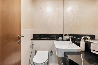 a bathroom with a toilet and a sink at Millennium Heights 1 in Dubai
