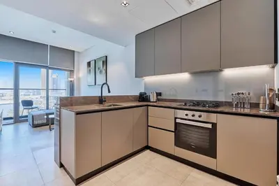 a kitchen with stainless steel appliances and a large window at Khalifa View Luxe 1BHK in Dubai