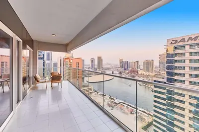 an apartment balcony with a view of the city at Cityscape Comforts 2BR in Dubai
