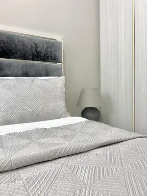 a bedroom with a white bed and a lamp at Cozy 1BR in Zada Tower Business Bay in Dubai