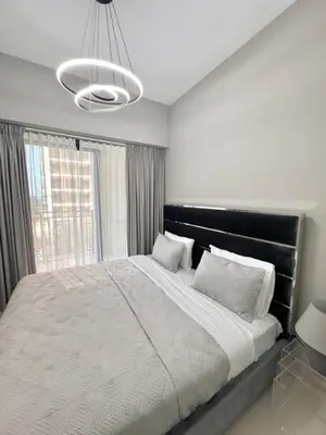 a bedroom with a large bed with a large window at Cozy 1BR in Zada Tower Business Bay in Dubai