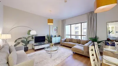 a living room with a couch and a tv at Vacationer I Luxury 2 Bedroom Apartment I Marina View I Steps from JBR Beach in Dubai
