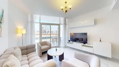 a living room with a couch and a tv at Vacationer l 1 Bedroom Perched on the 19th Floor l Free Pool, Gym Access in Dubai