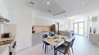 a kitchen and dining room with a table and chairs at Vacationer l 1 Bedroom Perched on the 19th Floor l Free Pool, Gym Access in Dubai
