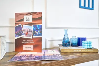a table with two posters and a vase on it at Full Ocean & Palm Views Apartments in JBR Beachfront with Dubai Eye Views in Dubai