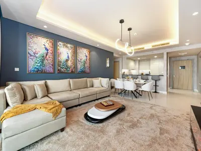 a living room with a couch and a table at ElysianSky Burj Khalifa Views 3 Bedroom Apartment at Paramount Hotel Midtown with 64th Floor Rooftop Pool in Dubai